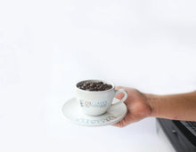 Load image into Gallery viewer, A person holding a cup of Degayo Coffee beans
