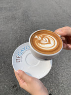A person holding a cup of Degayo Coffee 